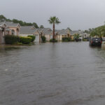 Flooded residential street after heavy rain - 6 Best Tips for Florida Homeowners: Safe Homes During Hurricane Season - Is Hurricane Insurance Required in Florida? - Florida flood season - Florida Mold Inspection & Indoor Air Quality Testing - Commercial, Residential & Marine Mold, Water and Air Quality Testing Services by ETA Mold