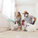 a man and woman kneeling in a room with spray bottles - 10 Warning Signs of Mold Toxicity and How to Protect Your Health - What Is Mold Toxicity? - 10 Signs You Might Have Mold Toxicity - How to Protect Your Health from Mold - How to Protect Your Health from Mold Toxicity - Mold Ispection in Florida - ETA Mold