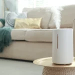 a white humidifier on a table in a living room - Mold in Humidifiers: What You Need to Know - ETA Mold Inspection