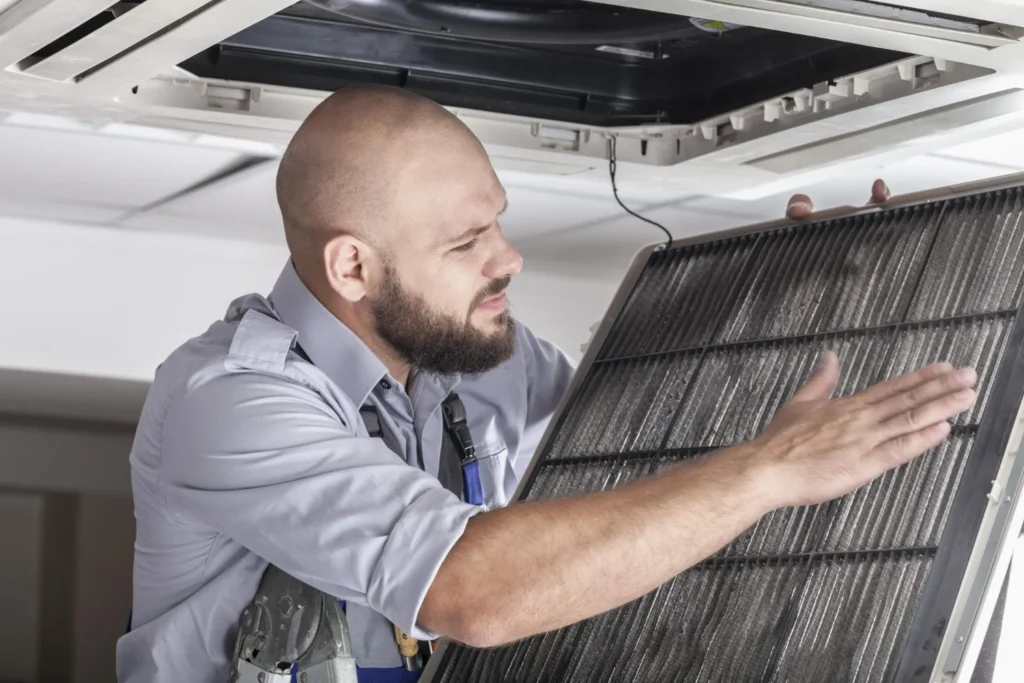 a man holding a air conditioner / How to Clean Mold From Your AC: A Complete Guide / What Causes Mold in Air Conditioners? / Is Mold in Your AC Harmful to Health? / Common Signs of Mold in Your Air Conditioner / How to Check for Mold in Your AC Unit / Step-by-Step: How to Get Rid of Mold From Your AC / When Should You Call a Professional? / How to Prevent Mold Growth in Your AC System / DIY vs. Professional Mold Removal: Which Is Better? / Final Thoughts: Take Mold in Your AC Seriously / FAQs About Mold in Air Conditioners / ETA Mold