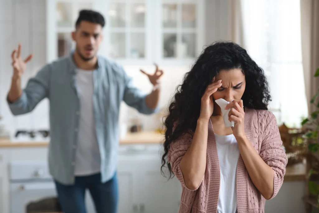 woman crying with angry man in background - Can Mold Make You Sick?