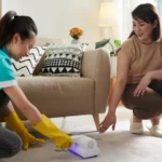 women cleaning carpet stains in a bright living room - Does Ultraviolet Light Kill Mold?